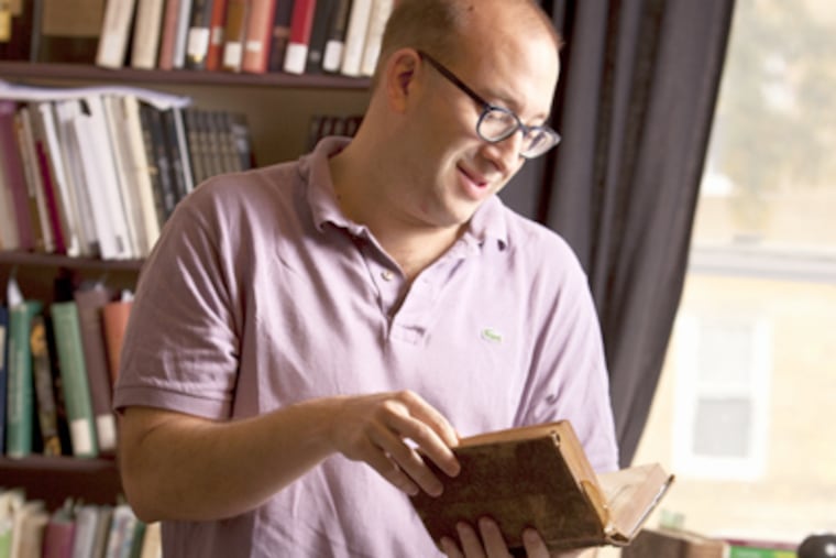 Jacob Soll looks over his copy of Abraham Nicolas de La Houssaye's "History of the Government of Venice." (Ed Hille / Staff Photographer)