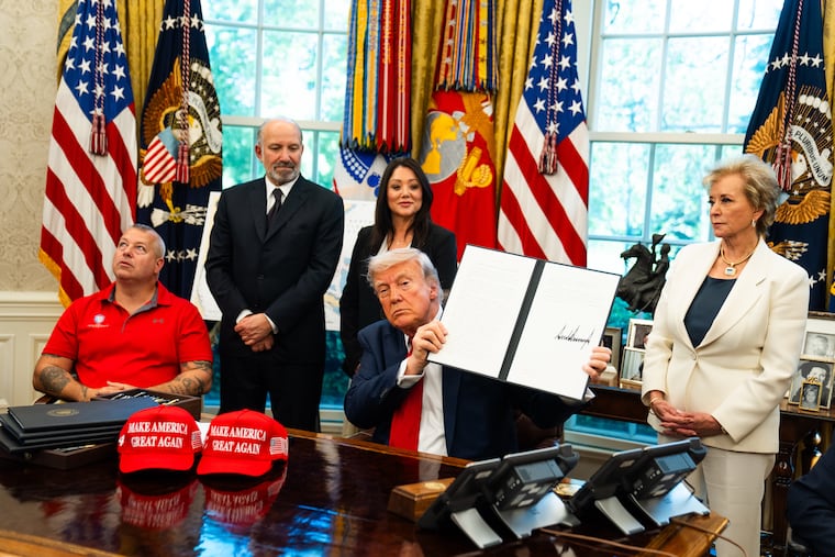 President Donald Trump signs an executive order related to education in the Oval Office of the White House on April 23, 2025.