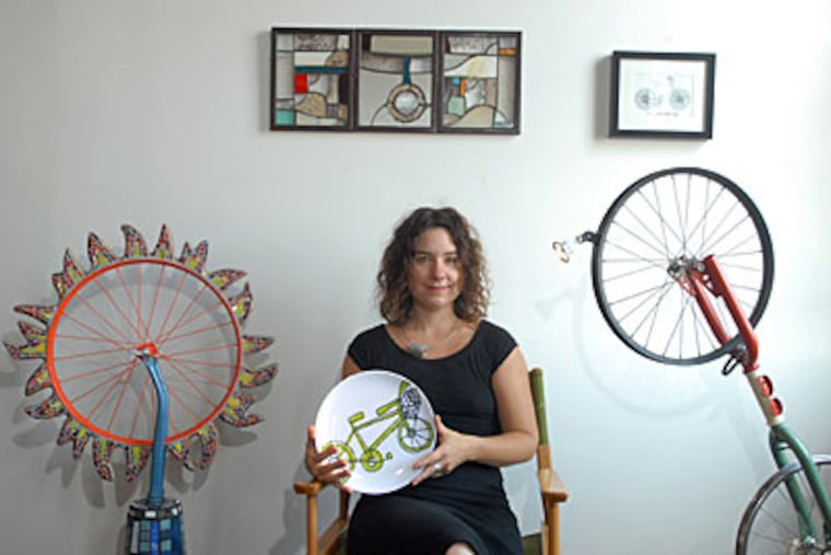 Kate Duncan, show organizer, with artwork that will be on display. (RON TARVER / Staff Photographer)