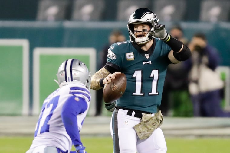 Carson Wentz looks to make a play as Dallas safety Donovan Wilson moves in. Wilson sacked Wentz and forced a fumble.