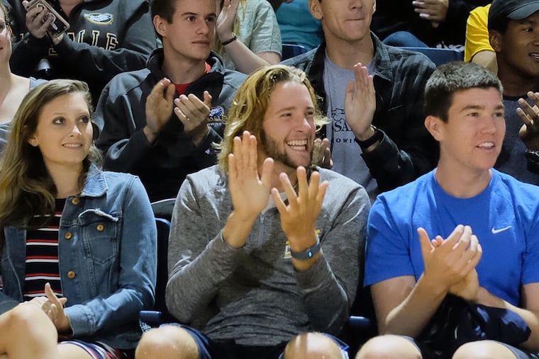 La Salle University freshman Gia Lanci (from left), junior Kieran Hughes and sophomore Robert Noga react to the news that their tuition is being reduced.