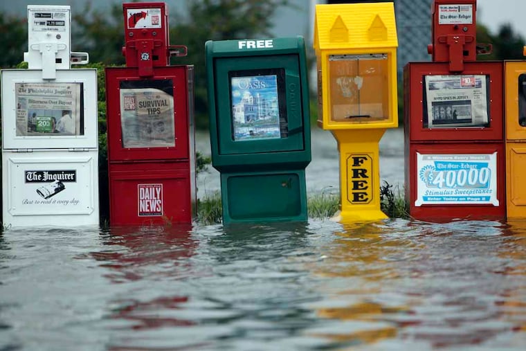 Flood water surrounds a row of newspaper boxes along Long Beach Island, N.J., in August 2011.