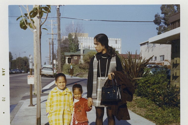 This January 1970 photo provided by the Kamala Harris campaign shows her (left) with her sister, Maya, and mother, Shyamala, outside their apartment in Berkeley, Calif., after her parents' separation. (Kamala Harris campaign via AP)