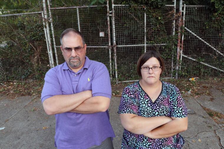 Bridesburg neighbors John Melone and Samantha Zeno are glad that Philly police are looking into the towing scam they say has held the neighborhood hostage. (STEVEN M. FALK/STAFF PHOTOGRAPHER)