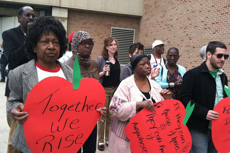 Workers at Philadelphia International Airport rally to urge the city's voters to approve a ballot question in 2014 to would increase the minimum wage for those employed by subcontractors.