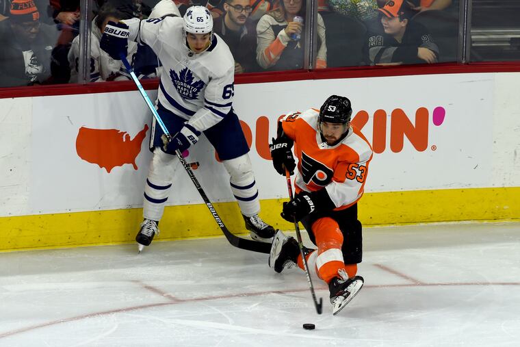 Flyers defenseman Shayne Gostisbehere (right) controls the puck in front of Toronto's Ilya Mikheyev during the 6-1 win at the Wells Fargo Center.