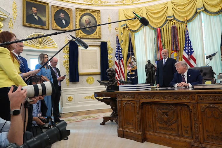 President Donald Trump answers questions from reporters after signing an executive order in the Oval Office of the White House Tuesday, March 31, 2026, in Washington, as Commerce Secretary Howard Lutnick listens. (AP Photo/Alex Brandon)