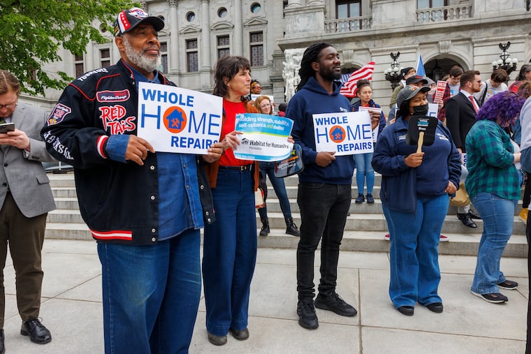 From left are Douglas Paige, Carrie Rathmann with Habitat for Humanity, Director of Strategic Partnerships, Tyron Cheeseboro and “wife” Danielle Paige on the steps of Pennsylvania Capitol during rally for Whole-Home Repairs Program along with other issues at Pennsylvania State Capitol on Monday, May 1, 2023.