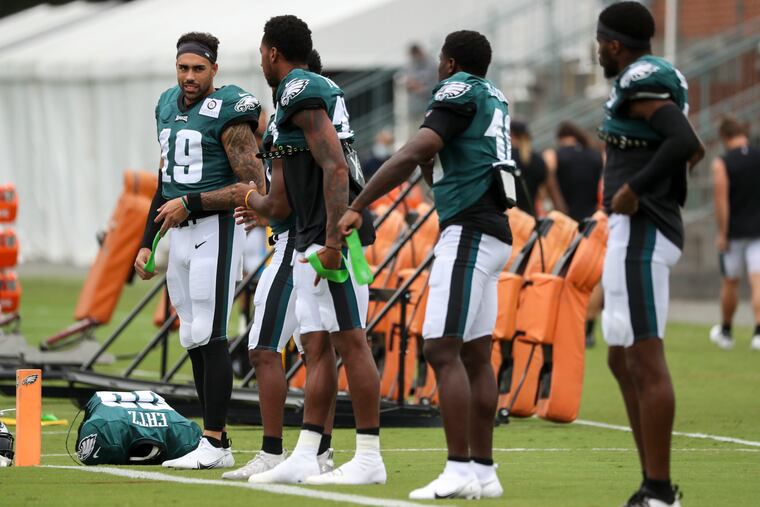 J.J. Arcega-Whiteside (left) talks with teammates during a recent practice.