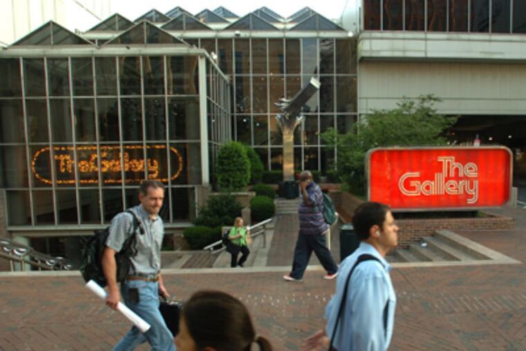 Morning commuters walk past the entrance to The Gallery on Market Street. Foxwood Casino is considering the site as a casino. (Clem Murray / Inquirer)