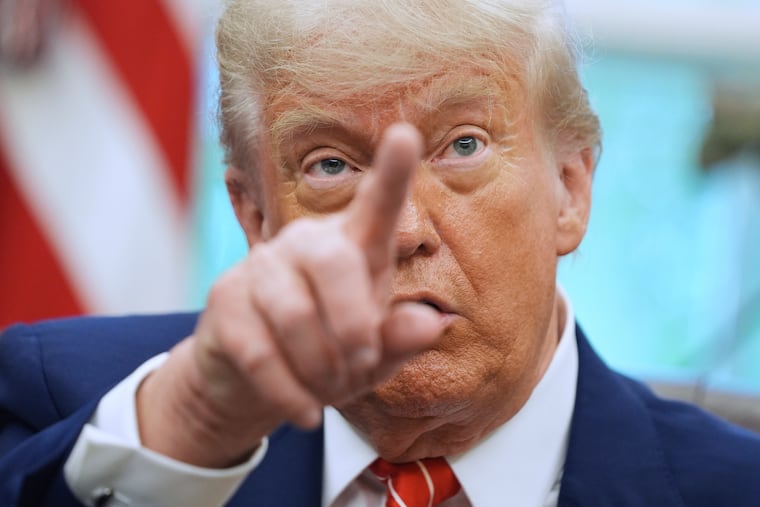 President Donald Trump gestures as he speaks with reporters in the Oval Office of the White House, May 8, 2025, in Washington.