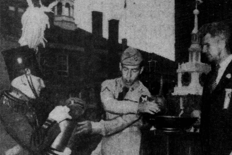 Outside Independence Hall on July 1, 1951, Army Pfc. Francis R. Findley Jr., of Havertown, who had recently returned from Korea, mixes earth from Independence Square with soil from Revolutionary War battlefields in a ceremonial pedestal bowl. He was aided by Theodore Smythe, of Cynwyd, Pa., who was wearing a uniform of the Washington Grays, 1777 Pennsylvania artillery corps. Looking on is Brig. Gen. Frank A. Howley.