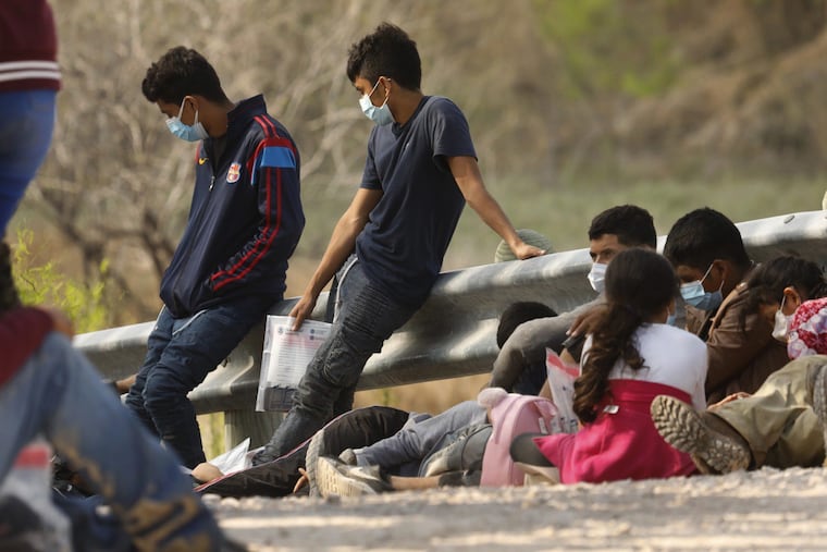 Asylum-seekers who crossed the U.S.-Mexico border wait to be processed outside Mission, Texas.