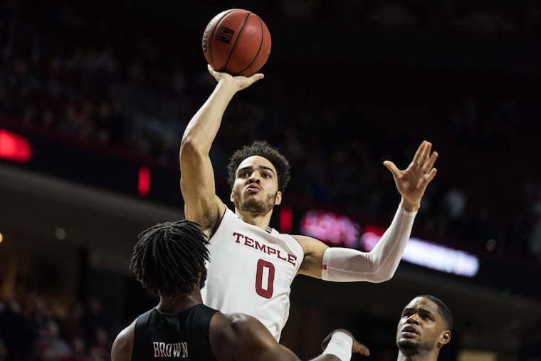 Senior forward Obi Enechionyia attempts a jump shot during the Owls' game against UCF at The Liacouras Center on Sunday, February 25, 2018. SYDNEY SCHAEFER / Staff Photographer