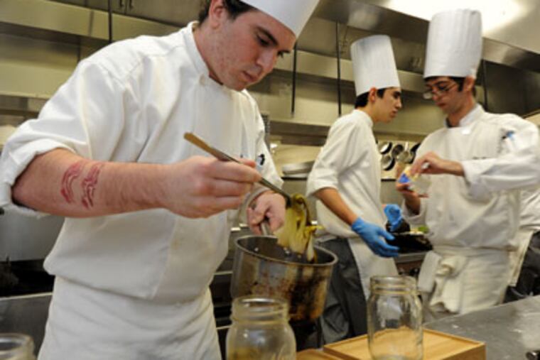 Thirty culinary students at Atlantic Cape Community College in Mays Landing compete in the 8th annual Student Chef competition on April 23, 2012. Here, Alexander Valletta of Brigantine places bok choy in pickle jars. APRIL SAUL / Staff Photographer
