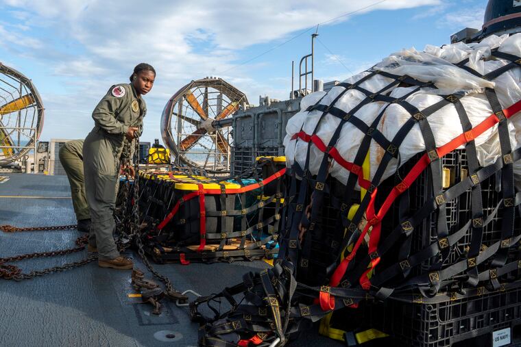 In this image released by the U.S. Navy, sailors assigned to Assault Craft Unit 4 prepare material recovered off the coast of Myrtle Beach, S.C., in the Atlantic Ocean from the shooting down of a Chinese high-altitude balloon, for transport to the FBI, at Joint Expeditionary Base Little Creek in Virginia Beach, Va., on Friday.