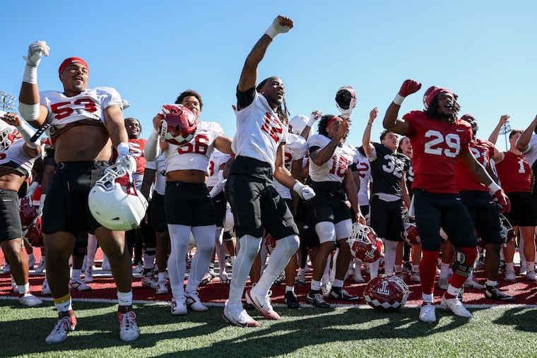 Temple football players take part in a collective postgame dance after the Cherry and White Spring Game at Edberg-Olson Hall on Saturday.