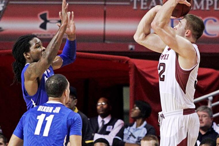 Memphis' Shaq Goodwin, and Michael Dixon Jr. (11) defend as Temple's Dalton Pepper, right, shoots a three in the first half of an NCAA basketball game, Saturday, Jan. 11, 2014, in Philadelphia. (H. Rumph Jr./A)