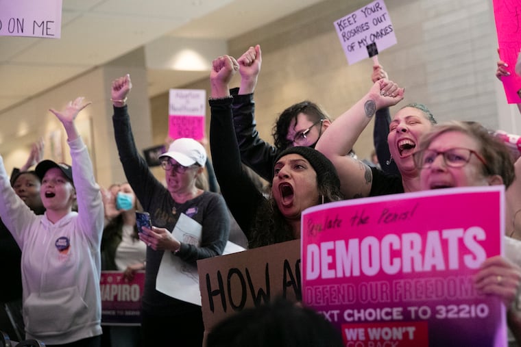 Gini George, center, reacts during a rally held by Pennsylvania Democrats at the Pennsylvania Convention Center in Philadelphia on Friday, May 6, 2022.