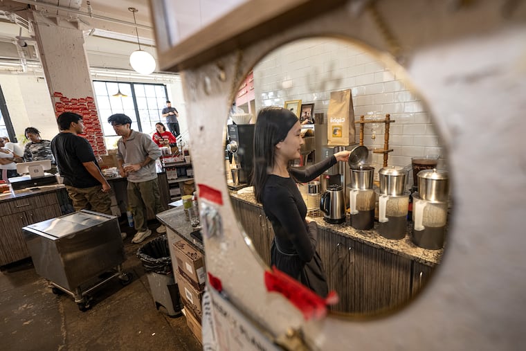 Tina Huynh, marketing and communications director at Càphê Roasters, prepares Vietnamese coffee at the Kensington shop on Thursday. Càphê Roasters raised prices 10% to 15% recently amid a 20% tariff on its Vietnamese beans.