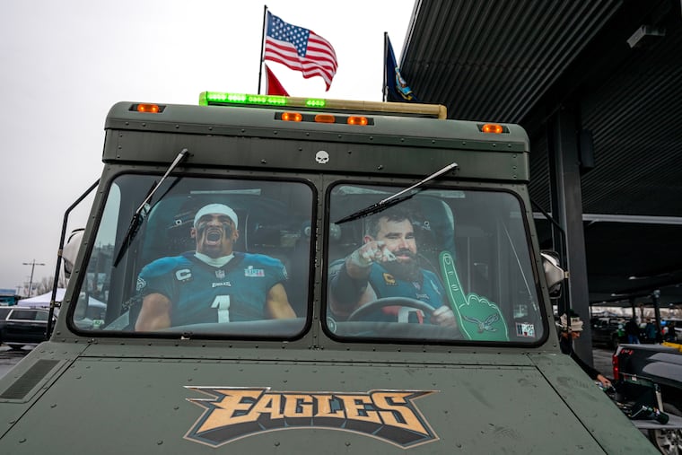 Cardboard cutouts of Eagles quarterback Jalen Hurts and former center Jason Kelce in a party vehicle.