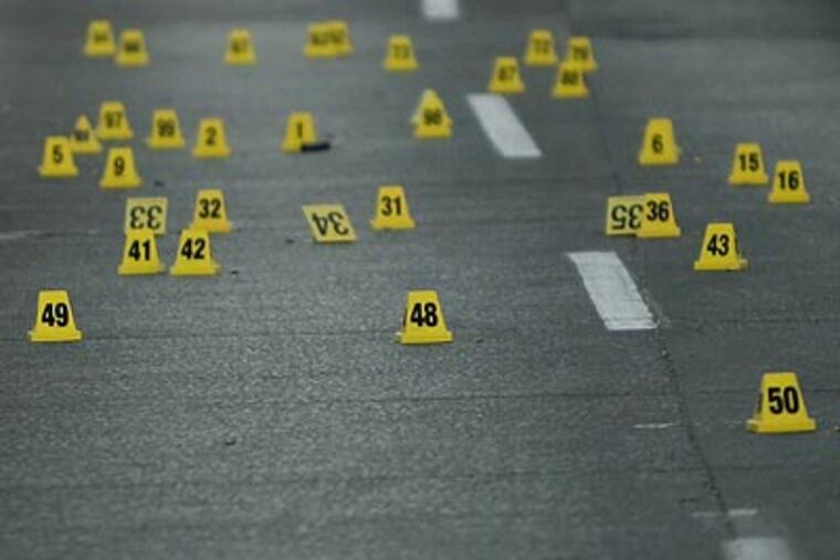 Numbered markers show where bullet casings were at a crime scene. (Eduardo Verdugo/AP file photo)