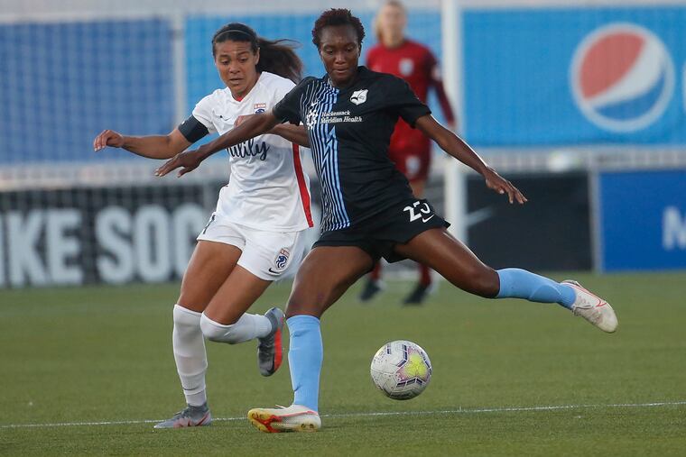 Sky Blue FC foward Ifeoma Onumonu (25) controlling the ball in front of OL Reign midfielder Shirley Cruz during the first half.