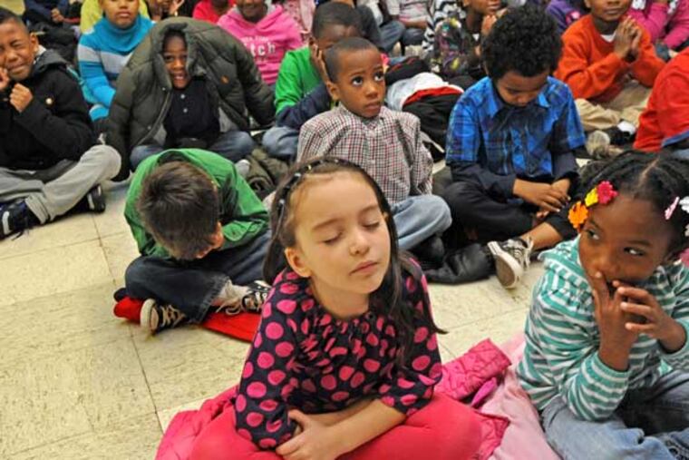 At Metropolitan Baptist Church, school children from Powell Elementary School observe a moment of silence in Dec. 2012. A coalition of civil- and human-rights groups has urged Gov. Corbett to release state funds for Philadelphia's cash-strapped schools and develop a new funding formula for education. (APRIL SAUL / Staff Photographer)