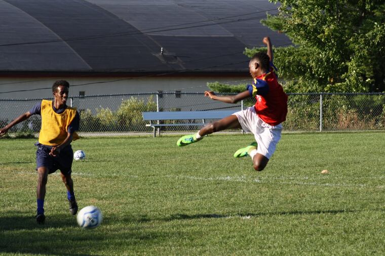 Abdiaziz Shaleh and Maulid Abdow of the Lewiston Blue Devils practice at Marcotte Park, in Lewiston, Maine. Soccer has helped bring immigrants together with long-time Maine residents, uniting the town.
