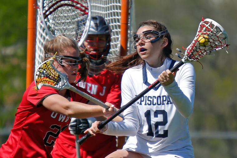 Olivia Dirks (12) of Episcopal Academy looks to get in scoring position while defended by Sophia Murray of Owen J. Roberts in front of goalie Cayden Jarvis during the first half at the Katie Samson Lacrosse Festival on Saturday, April 27, 2019 at Radnor. Episcopal went on to win, 16-12. LOU RABITO / Staff