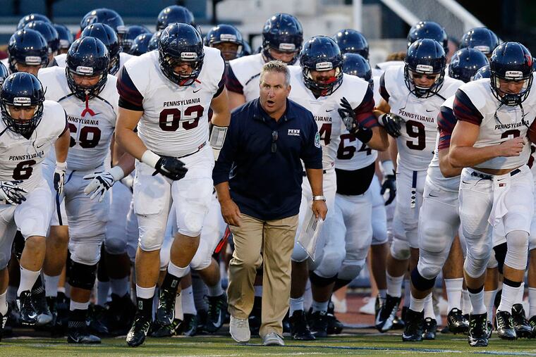 Penn coach Ray Priore leading his team onto the field for a 2018 game.