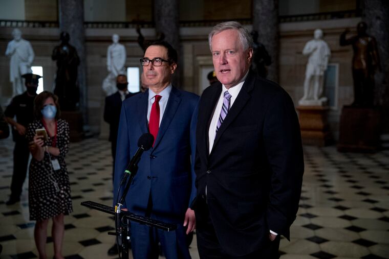 White House Chief of Staff Mark Meadows, right, accompanied by Treasury Secretary Steven Mnuchin, left, speaks to reporters after meeting with House Speaker Nancy Pelosi of Calif. and Senate Minority Leader Sen. Chuck Schumer of N.Y. on Capitol Hill in Washington on Friday.