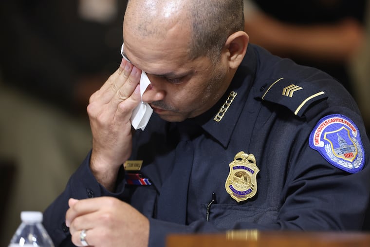 U.S. Capitol Police Sgt. Aquilino Gonell wipes his eye as he watches a video being displayed during a House select committee hearing on the Jan. 6 attack on Capitol Hill in Washington, July 27, 2021.
