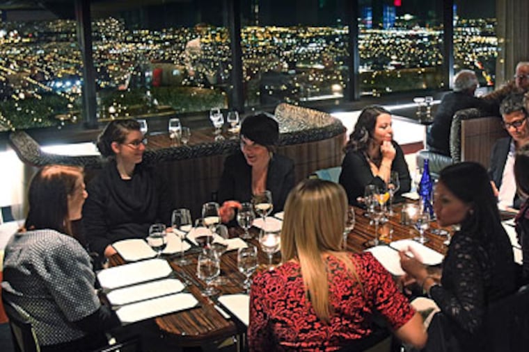 City lights create the backdrop for diners at R2L at Two Liberty Place. (David M Warren / Staff Photographer)