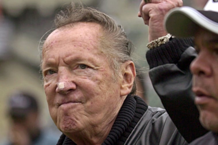 Oakland Raiders owner Al Davis gestures to fans before a 2004 Raiders game against the Denver Broncos, in Oakland, Calif. (Paul Sakuma / Associated Press, file)