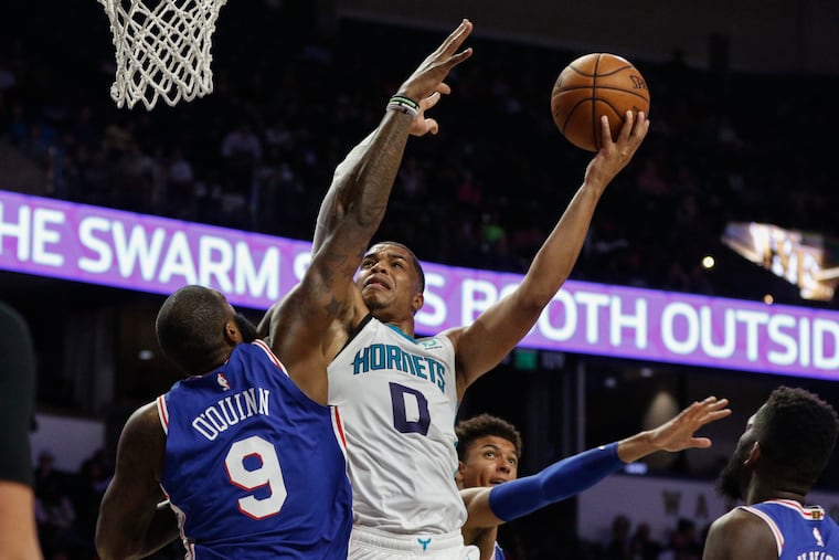 Charlotte Hornets forward Miles Bridges (0) shoots against Philadelphia 76ers center Kyle O'Quinn (9) and Matisse Thybulle (center) in the second half of a preseason NBA basketball game in Winston-Salem.