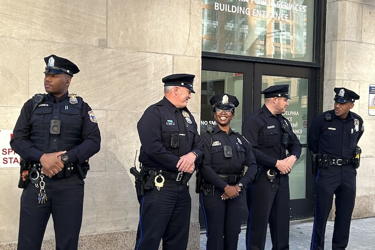 Philadelphia police officers pose in their new "midnight blue" uniforms, which return to the look that the department held before the 1970s.