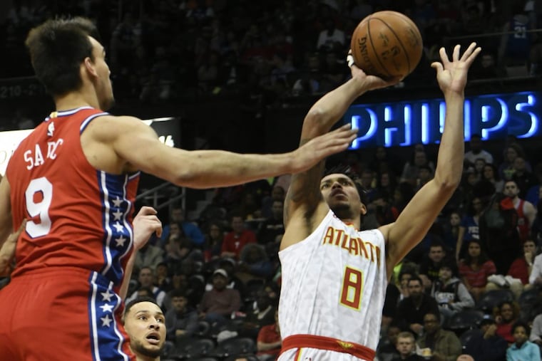 Atlanta Hawks guard Damion Lee (8) shoots as Philadelphia 76ers forward Dario Saric looks on during an NBA basketball game Friday, March 30, 2018, in Atlanta.