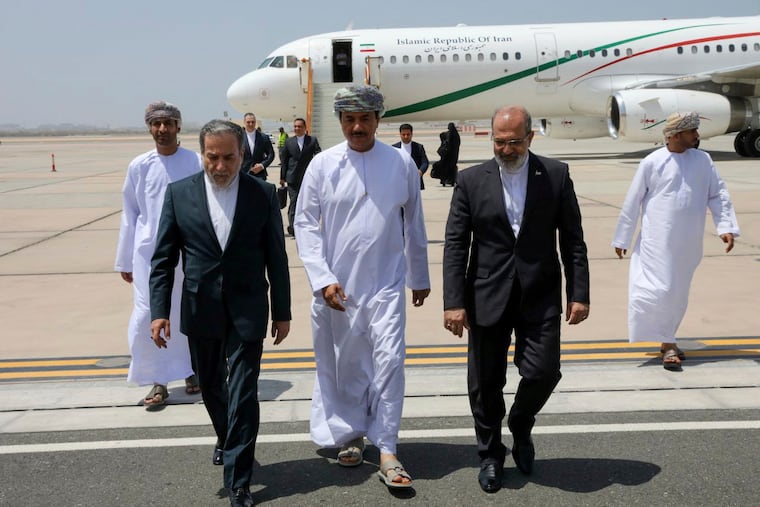 Iranian Foreign Minister Abbas Araghchi (left) is welcomed by Omani officials upon his arrival in Muscat, Oman, for negotiations with U.S. Mideast envoy Steve Witkoff last May.