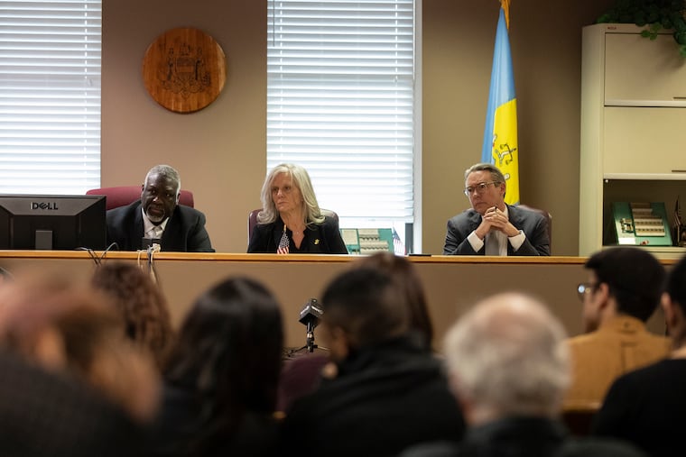 Philadelphia City Commissioners Anthony Clark, left, Lisa Deeley, and Al Schmidt listen as people speak in protest of new voting machines during a hearing in the Spring Garden section of Philadelphia on Wednesday, Feb. 20, 2019. The commissioners ultimately voted in favor of the new machines, which will cost as much as $50 to $60 million.