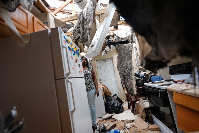 Natasha Ducre surveys the kitchen of her devastated home, which lost most of its roof during the passage of Hurricane Milton, in Palmetto, Fla., on Thursday, Oct. 10, 2024. Ducre, her husband, three children, and two grandkids rode out the storm in a government shelter and returned to find their home unlivable and much of their furniture and belongings destroyed by rainwater.