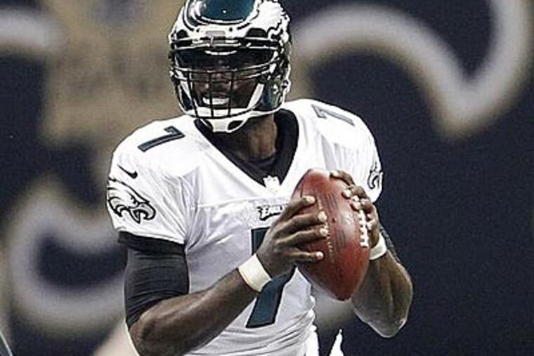 Michael Vick looks to pass the ball during the first quarter of their game against the Saints. (Ron Cortes/Staff Photographer)