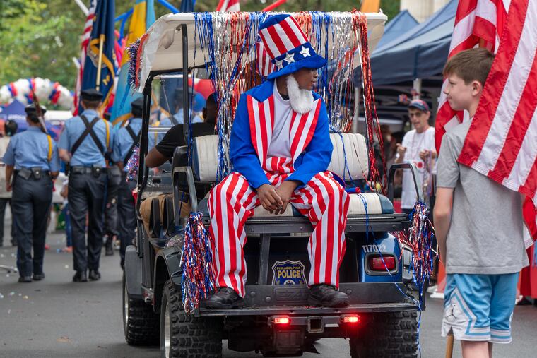 Elijah Thomas,14, with the Philadelphia Police Explorer Cadets rides as Uncle Sam.