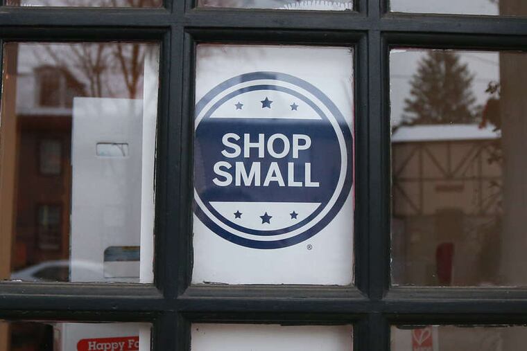 Shop Small sign in a window in Chestnut Hill Saturday November 28, 2014.