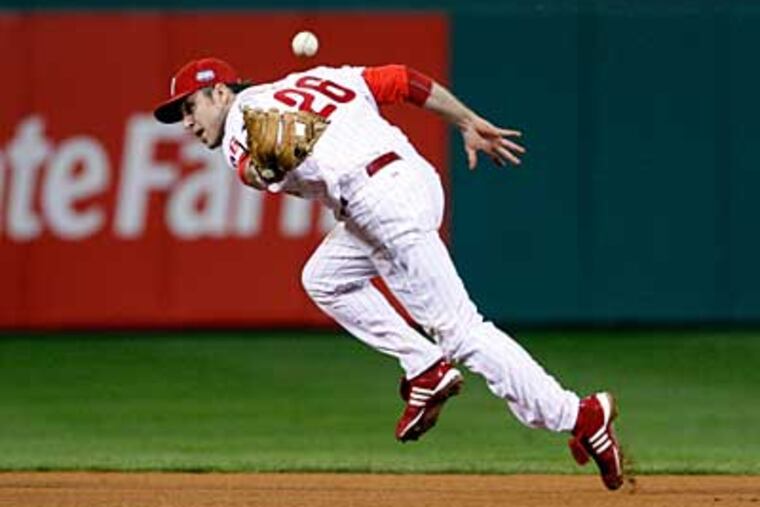 Chase Utley flips the ball to Jimmy Rollins but can not get the forced out
at second in the fifth inning of Game 4. ( Ron Cortes / Staff Photographer )