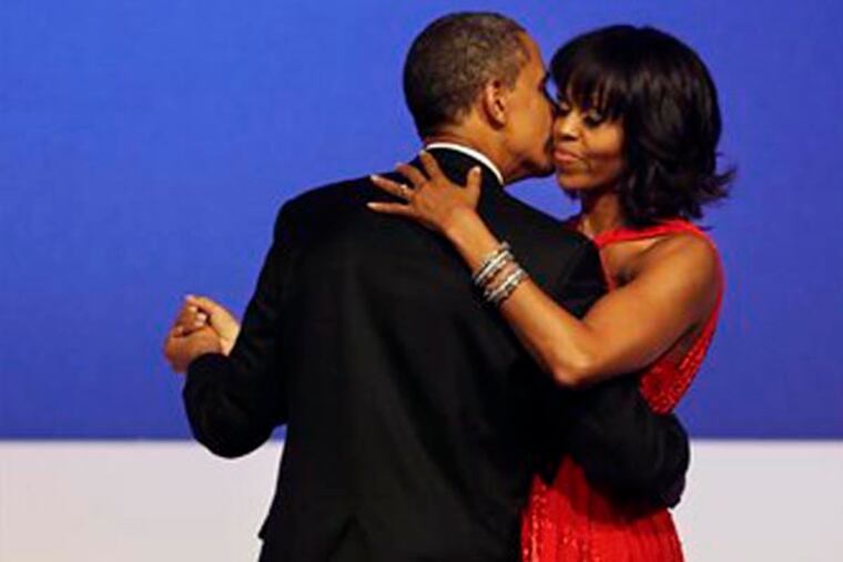 President Barack Obama kisses first lady Michelle Obama on the cheek during their dance together at the Commander-in-Chief Inaugural Ball in Washington, at the Washington Convention Center during the 57th Presidential Inauguration Monday, Jan. 21, 2013. (AP Photo/Jacquelyn Martin)