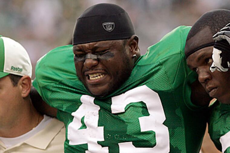Leonard Weaver leaves the field after injuring his knee during the second quarter against the Green Bay Packers. (Yong Kim/Staff Photographer)