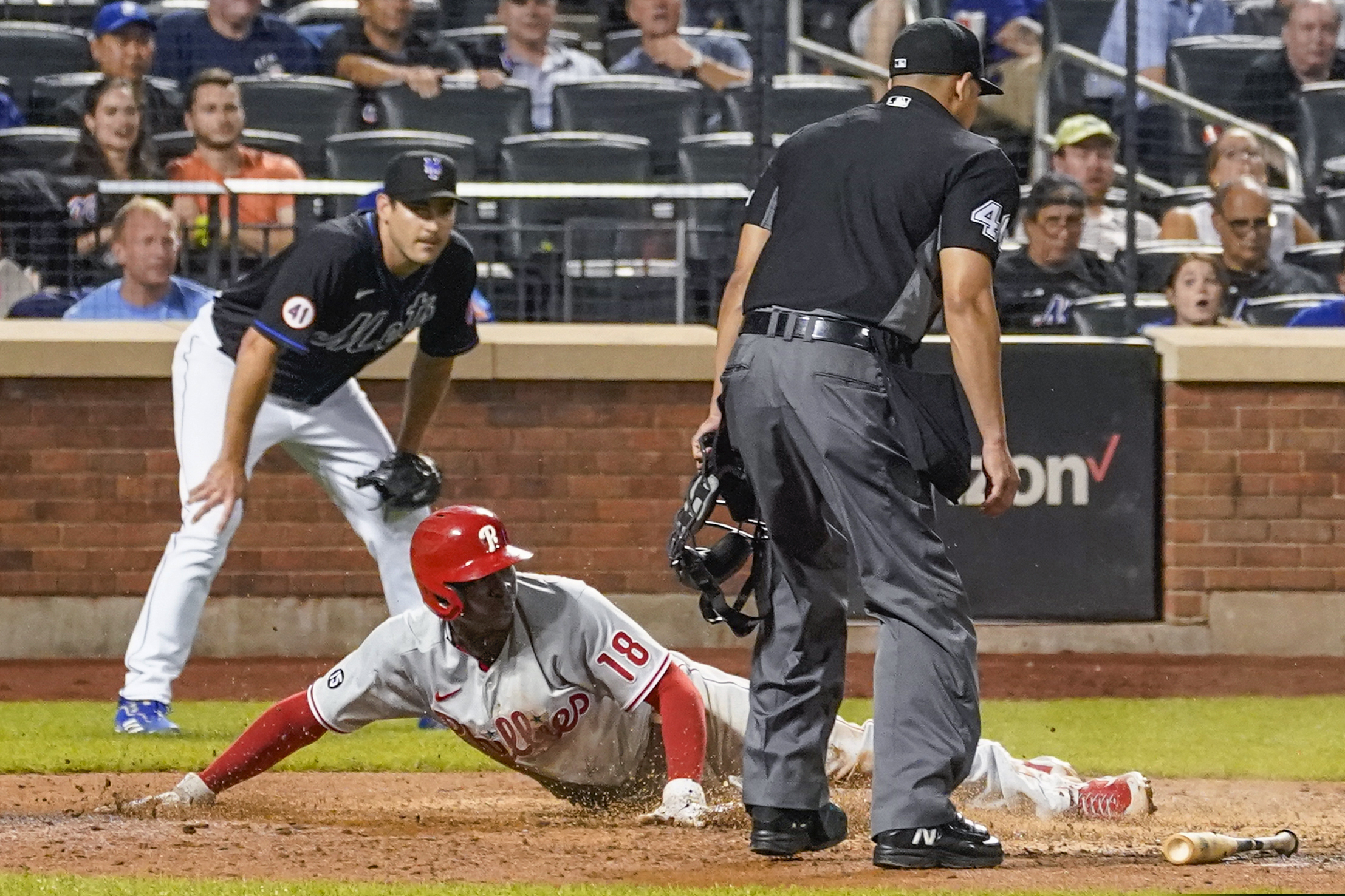 Didi Gregorius (18) slides into home to score on a sacrifice fly by Matt Vierling in the seventh inning of the Phillies' 4-3 win over the Mets Friday night.