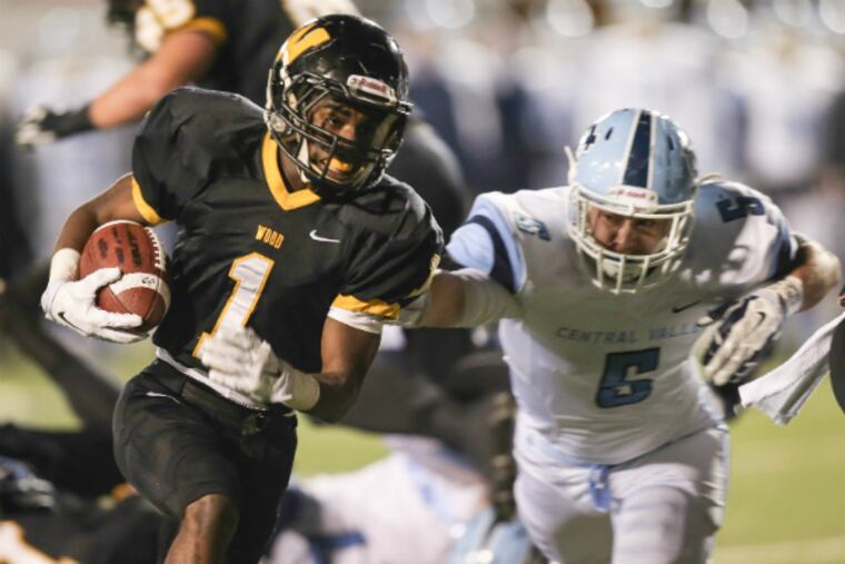 Wood’s Jarrett McClenton shakes off Central Valley’s Kurt Reinstadtler for his second touchdown run of first quarter.