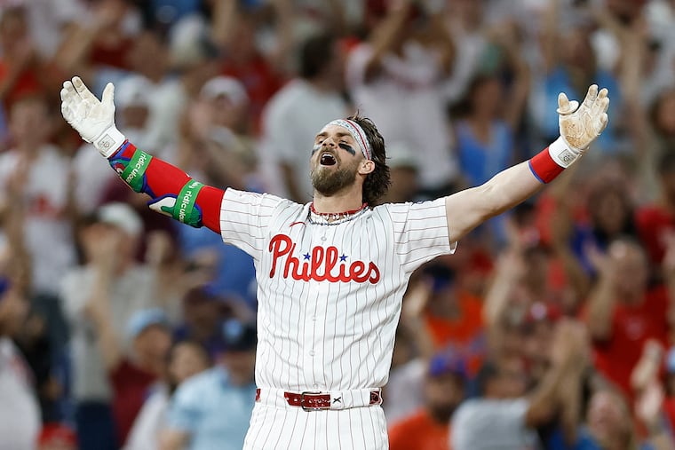 Phillies' Bryce Harper celebrates his fifth inning two-run triple against the Mets that gave him his first-career cycle.